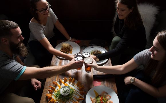 group of friends cheerings over dinner