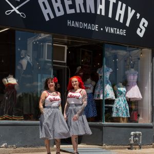 image of becca and red standing outside of abernathy's storefront