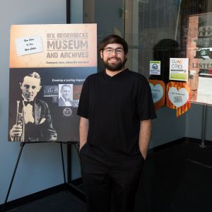 image of Nathaniel Kraft standing by Bix poster