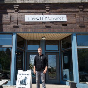 image of neil standing outside of the city church
