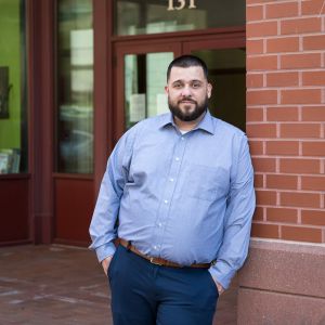 image of Josh Graves standing outside the Redstone building