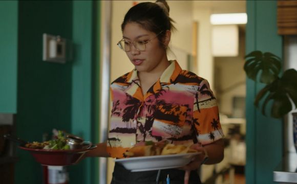 A lady carrying two dishes
