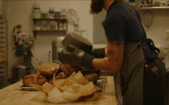 a man dumping out fresh bread