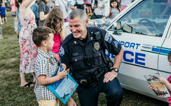 Police Officer & Kid smiling