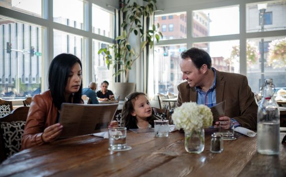 family at dinner looking over the menu choices 
