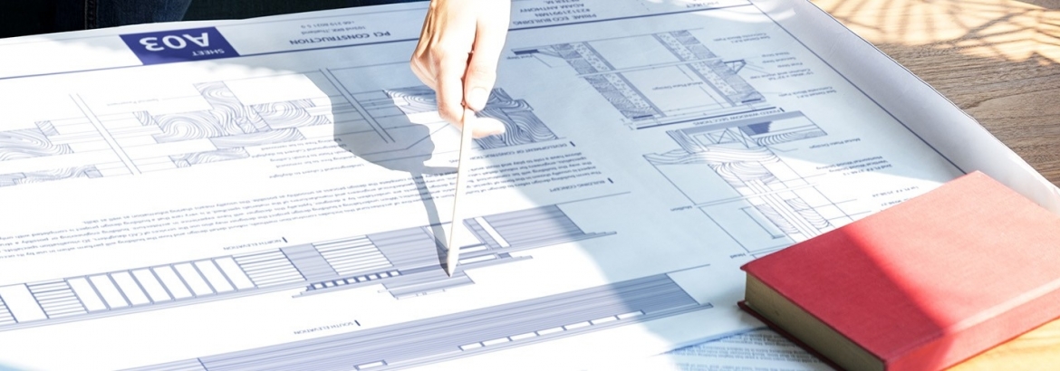 couple looking at an outline or chart of research information 