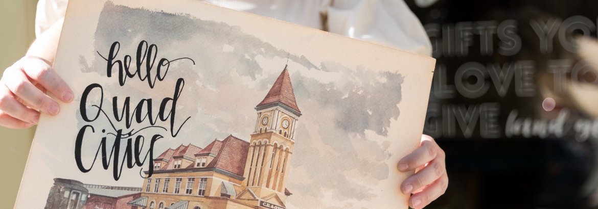 image of sarah holding hello quad cities artwork